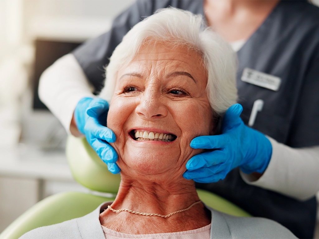 happy elderly patient in clinic for root canal treatment