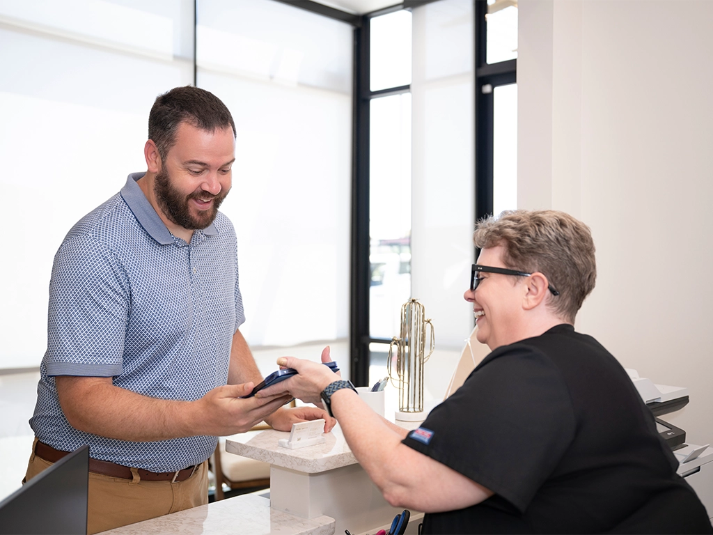 Oak-Creek-Endodontics-happy patient checking in for appointment